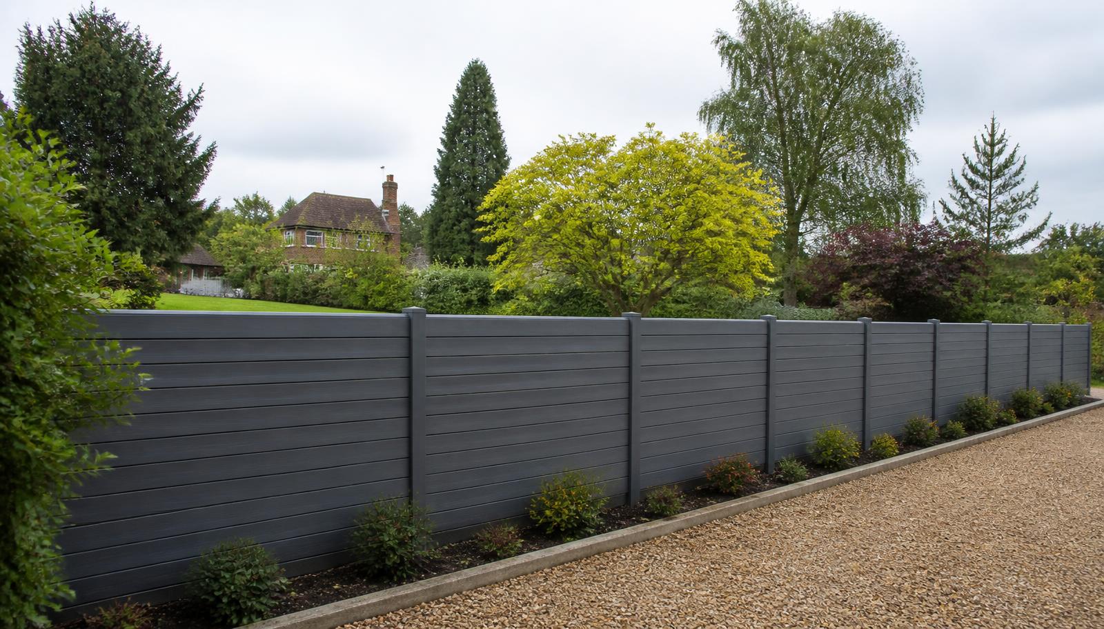 Example of a grey composite slatted fence enclosing a large landscaped Surrey garden
