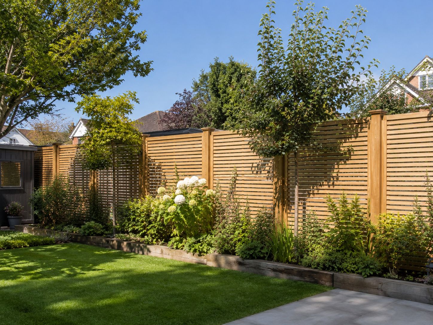 Slatted contemporary fence on an Esher boundary line