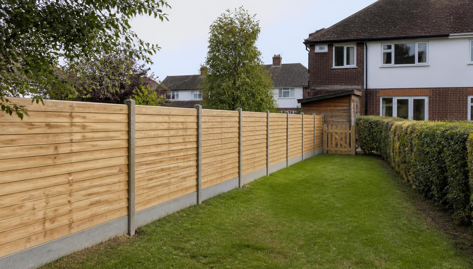 Example of a new overlap panel fence with concrete posts along a suburban side boundary
