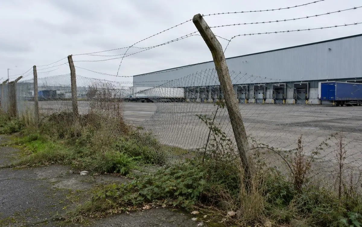Example before: Sagging chain-link and barbed wire around a working HGV yard.